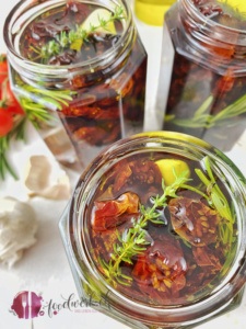 Getrocknete Tomaten und frische Kräuter im Glas