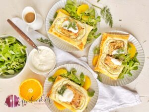 Frischer Lachs mit Zitronenpfeffer mariniert, auf Frischkäse und Blätterteig gebacken mit Nüsslisalat und Orangen